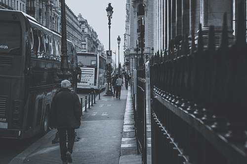 human grayscale photography of people walking on sidewalk grey