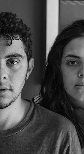 person grayscale photography of woman behind man black-and-white