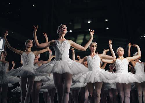 ballet group of ballerinas dancing while raising both hands dance