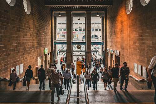 person group of people entering a brown hallway human