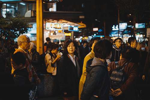 person group of people gathering on street during night time human
