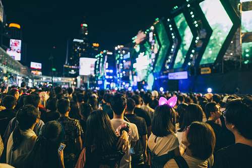 human group of people in an area surrounded by buildings crowd