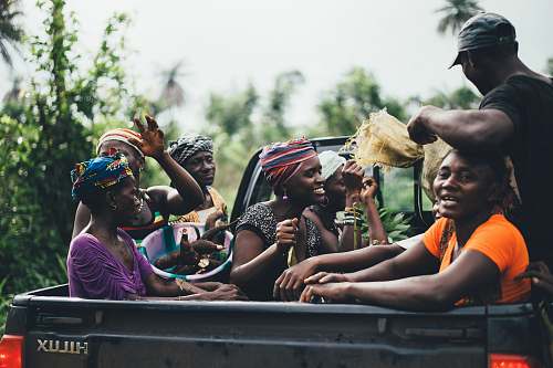 human group of people on black Toyota Hilux truck bed person