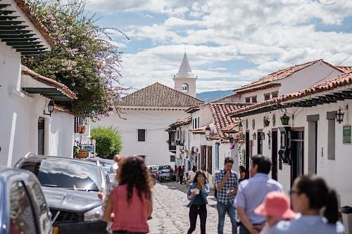 human group of people standing on sidewalk during daytime person