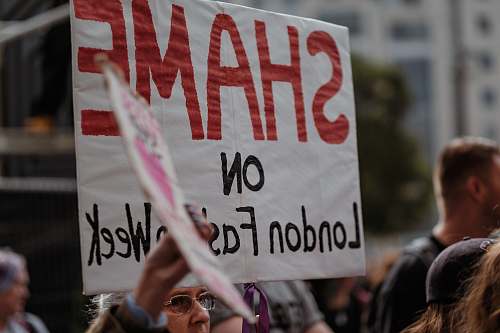 human group of person waving banner crowd