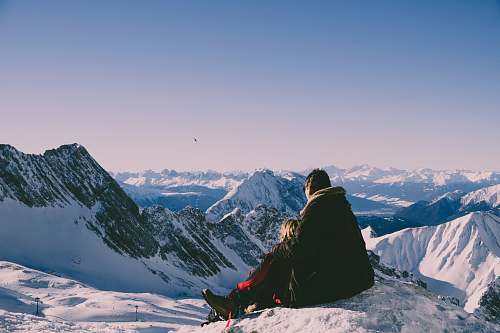 mountain man and woman on top of peak outdoors