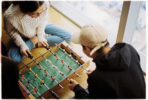 human man and woman playing foosball table person