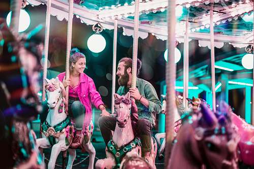 carousel man and woman riding a carousel leisure activities