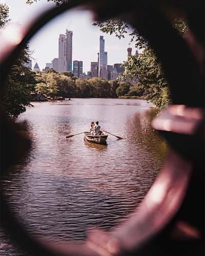 human man and woman riding on gray wooden boat person