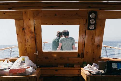 human man and woman sitting in front of boat person