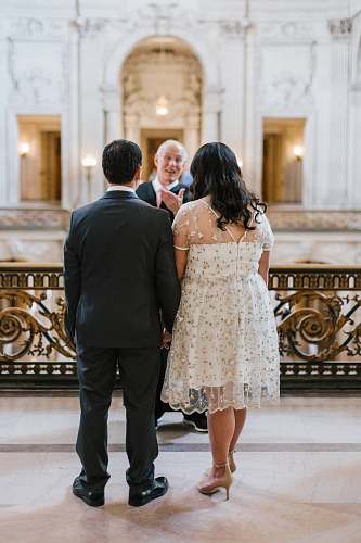 person man and woman standing in front of man wedding