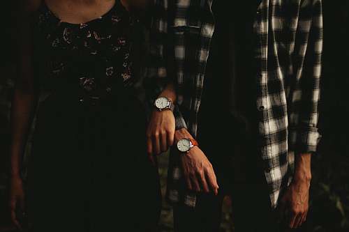 human man and woman standing while holding hands person