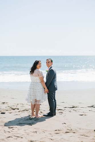 person man and woman walking beside body of water human