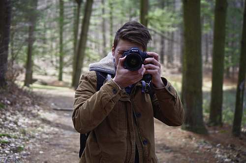 human man holding brown coat person