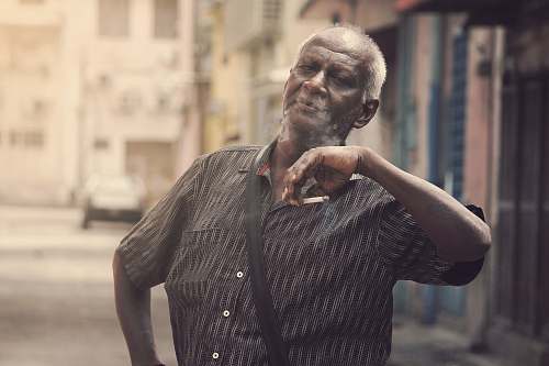 person man holding cigarette during daytime india