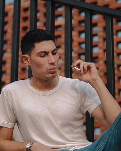 human man holding cigarette person