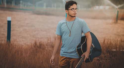 person man holding cutwaya acoustic guitar human