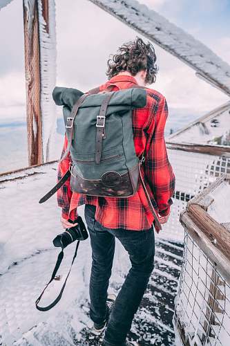 human man holding DSLR camera person