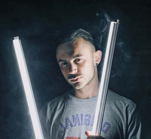 human man holding lit fluorescents person