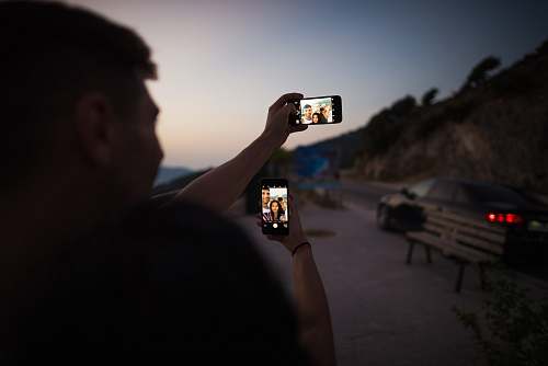person man holding smartphone during daytime human