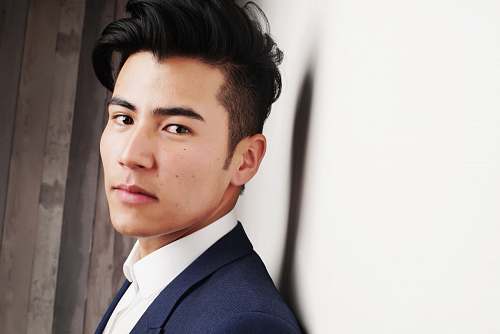 human man in blue formal suit jacket posing for picture person