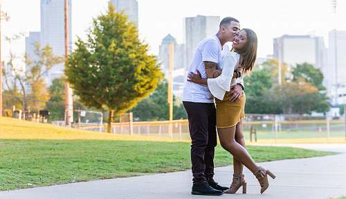 person man kissing woman's cheek during daytime human