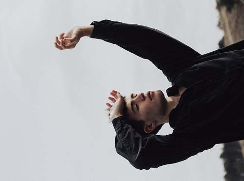 human man raising his arms person