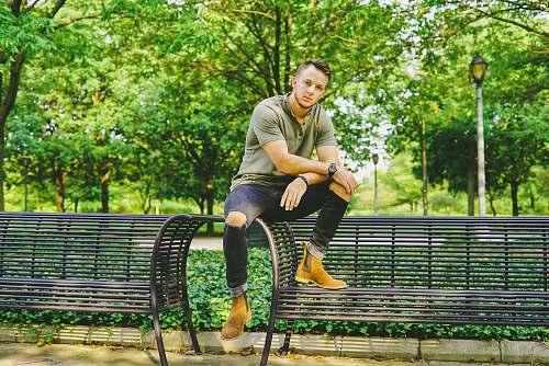 human man seating on bench person
