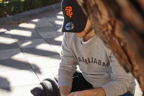 person man sitting beside tree human
