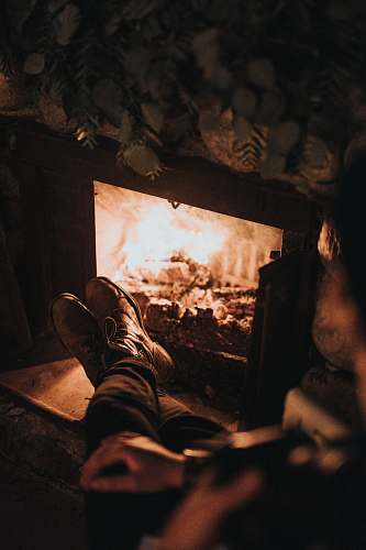 human man sitting in front of the fireplace person