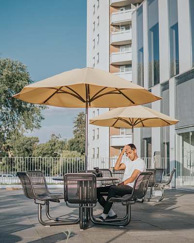person man sitting on black metal chair chair