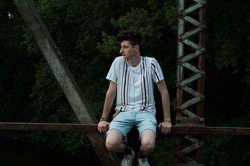 person man sitting on bridge human