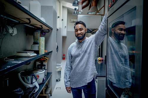 person man standing in kitchen human