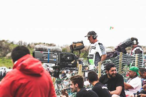 human man standing near black and gray video camera person