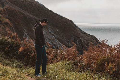 person man standing near mountain cliff human