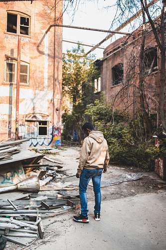 person man standing nearby metal frames human