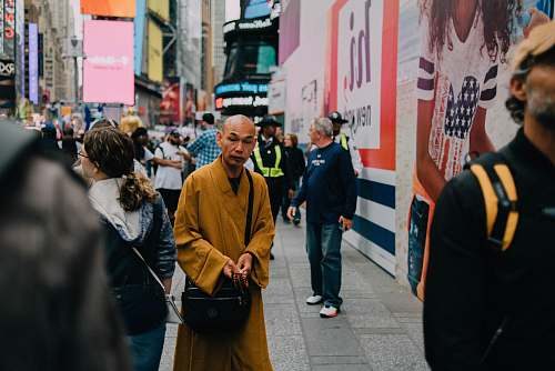 human man standing nera wall crowd