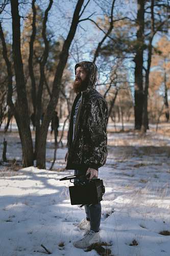 human man standing on snow ground person