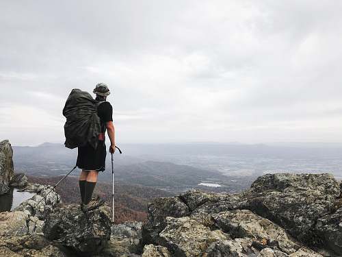 human man standing on top of mountain person