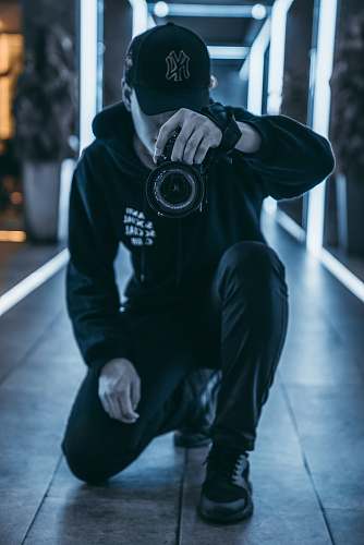 human man taking camera while taking picture inside building person