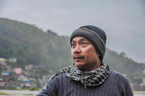 person man wearing black knit cap looking left human
