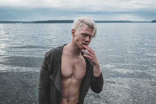 person man wearing black top near body of water human