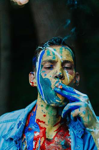 human man wearing blue shirt while smoking person