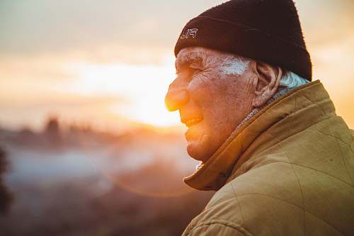 human man wearing brown jacket and knit cap person
