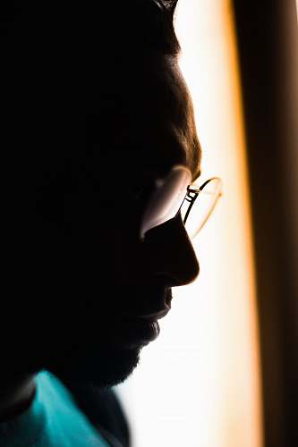human man wearing eyeglasses and teal crew-neck tops in close-up photography person