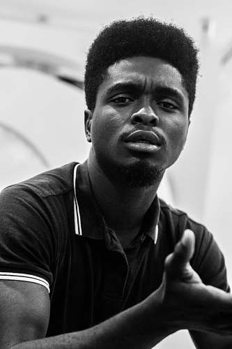 human man wearing polo shirt taking selfie black-and-white