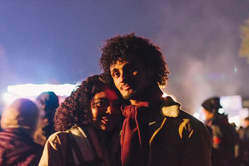 hair man wearing red scarf standing beside woman afro hairstyle
