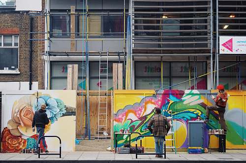 person men painting graffiti on wall human