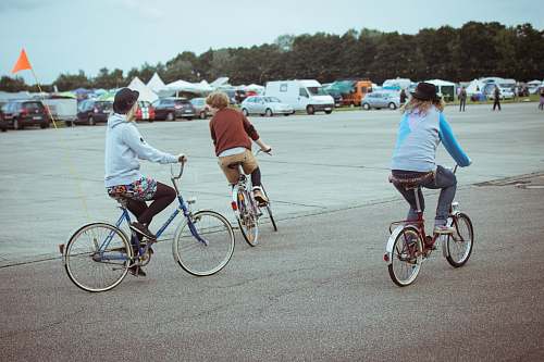 human people riding bicycle bike