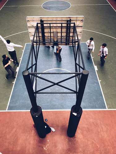 human people standing under basketball hoop person